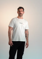 Man wearing a white t-shirt with text on a gradient background